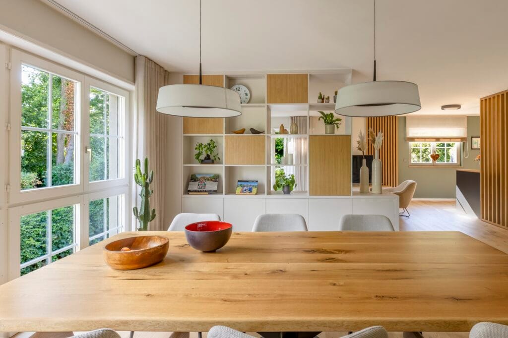 Détail de la table de salle à manger avec vue sur la grande séparation semi ouverte, par Etymodéco, Magali Brustlein, Décoratrice d'intérieur à Saint Louis en Alsace